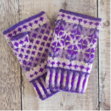 Colorwork mitts with flower and diamond motifs in four or five monochromatic shades.