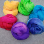 Small dabs of spinning fiber in six colors of the rainbow.