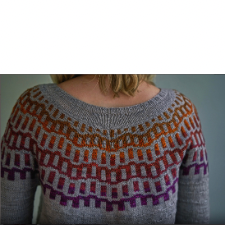 Pullover yoke has staggered colorwork rectangles in wavey rows, some reversed. The contrasting yarn is a gradient, which works beautifully.