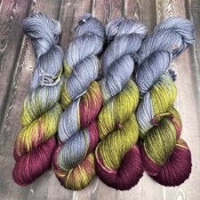 Variegated yarn in cool gray, maroon and olive green.