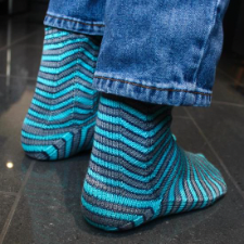 Striped socks that have bends in the stripes like reflections from glass or water.