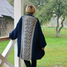 Loose knee length cardigan has a wide panel down the back with a leave texture. Panel is a contrasting color.