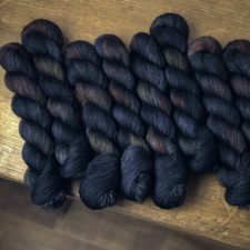 Variegated skeins with colors of a very dark rainbow.