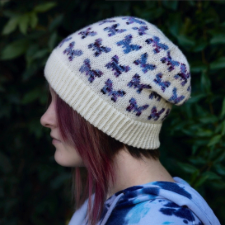 Slouchy beany has rows of butterfly silhouettes, made fancy with variegated yarn.