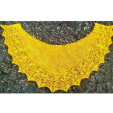 Semi-circular shawl with sharply geometric textured border at bottom edge.