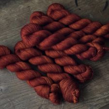 Semisolid yarn in a deep red-orange.