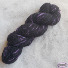 Primarily black yarn with bright, cool streaks.