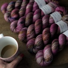 Row of skeins in colors of roses and dry leaves.