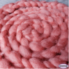 Coiled braid of fiber in solid, warm tone.
