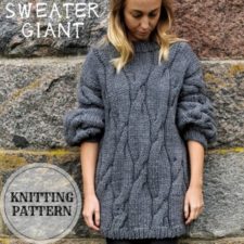 Long, bulky sweater with loose cables throughout.