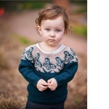 Toddler wears pullover with colorwork monarch butterflies.