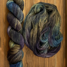 Variegated yarn in a warm, brown base with cool splashes of teal and purple.