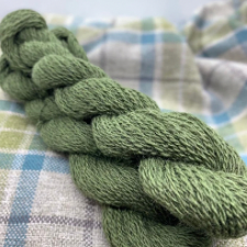 Medium green woolen spun Shetland yarn.
