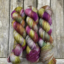 Yak, silk and merino yarn in soft moss green and deep mulberry.