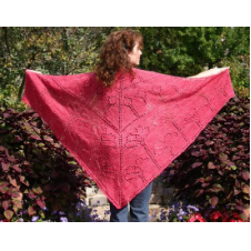 Large, triangular shawl that is mostly solid with yarnover poppy motifs from buds to full blooms.