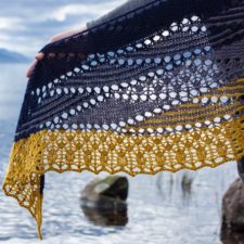 Lacy shawl knitted in crescents, some with a lacy effect, joined by yarnovers.