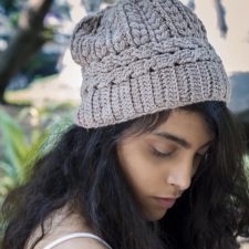 Beanie with braided motif around brim and along crown.