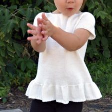 Short-sleeve top for small child with 3-inch ruffle at hem.
