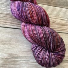 Variegated skein in berry colors.