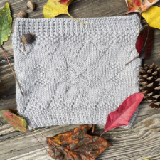 Knitted cowl with textures inspired by Danish relief-stitch designs.