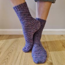 Socks with traveling cables that wrap around the foot and leg in a spiral.