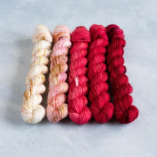 Set of yarns in a gradient from toasted marshmallow to deep red