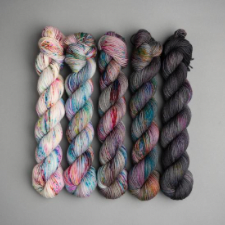Variegated gradient from cream with blues and pinks to deep gray.