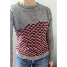 Long-sleeve pullover with tiny contrasting triangles in an asymmetric stack.