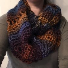 Fluffy crocheted infinity scarf in warm tones.