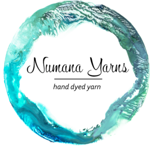 Logo looks like a watercolor painting of a circle with Numana Yarns, Hand dyed yarn written inside