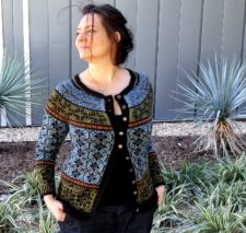 Colorwork button-up cardigan with geometric motifs in five sections.