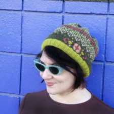 Colorwork hat with geometric and floral motifs in several colors.