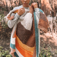 Garter stitch blanket in right-angle sections in different colors of solid bulky yarn.