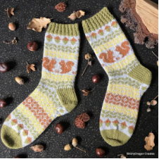 Multi-color socks with squirrel motif and other patterns in stripes throughout.