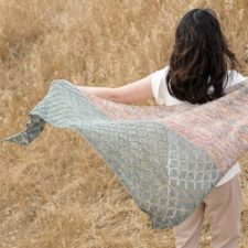 Bias triangular shawl knit in two large color blocks. The latter portion includes simple lace.