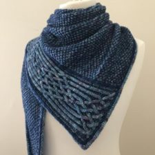 Moss-stitch shawl with intricate cabled edge.