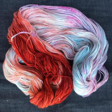 Variegated yarn that is half rust color and half cool pastels.