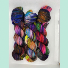 Scorpio Rising is a deep and moody burgundy yarn with washes of green, blue, red, pink and purple.