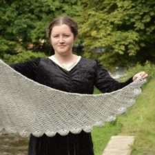 Textured crescent shawl with scalloped edge.