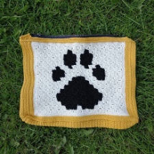 Zippered colorwork bag with a dog paw design.