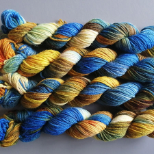 Variegated yarn in warm tan and cool blue tones.