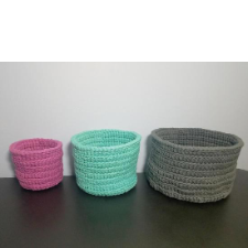 Three small to large crocheted baskets on a table.