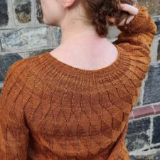 Wide neck sweater with sleeves just past the elbow. Texture through out is diamond shaped.