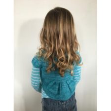Child wearing short jacket with pleated hem
