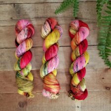 Bright, variegated skeins in carnation colors.