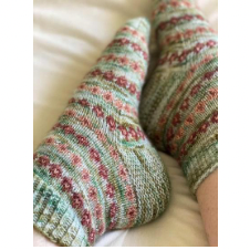 Short-cuff colorwork socks with rows of circular motifs.