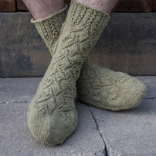 Socks have a lacy ribbing at the top and an overlapping-leaves texture.