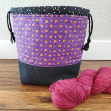 Drawstring bag for smaller projects. Print has tiny pumpkins with Halloween background colors.
