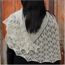 Crescent shawl with stockinette top, then complex lace blocked to gentle points on the bottom edge.