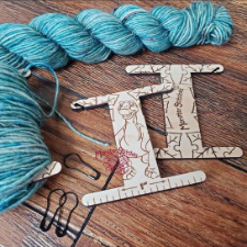 Bobbins for mini-skeins or intarsia with cartoon dinosaur design.